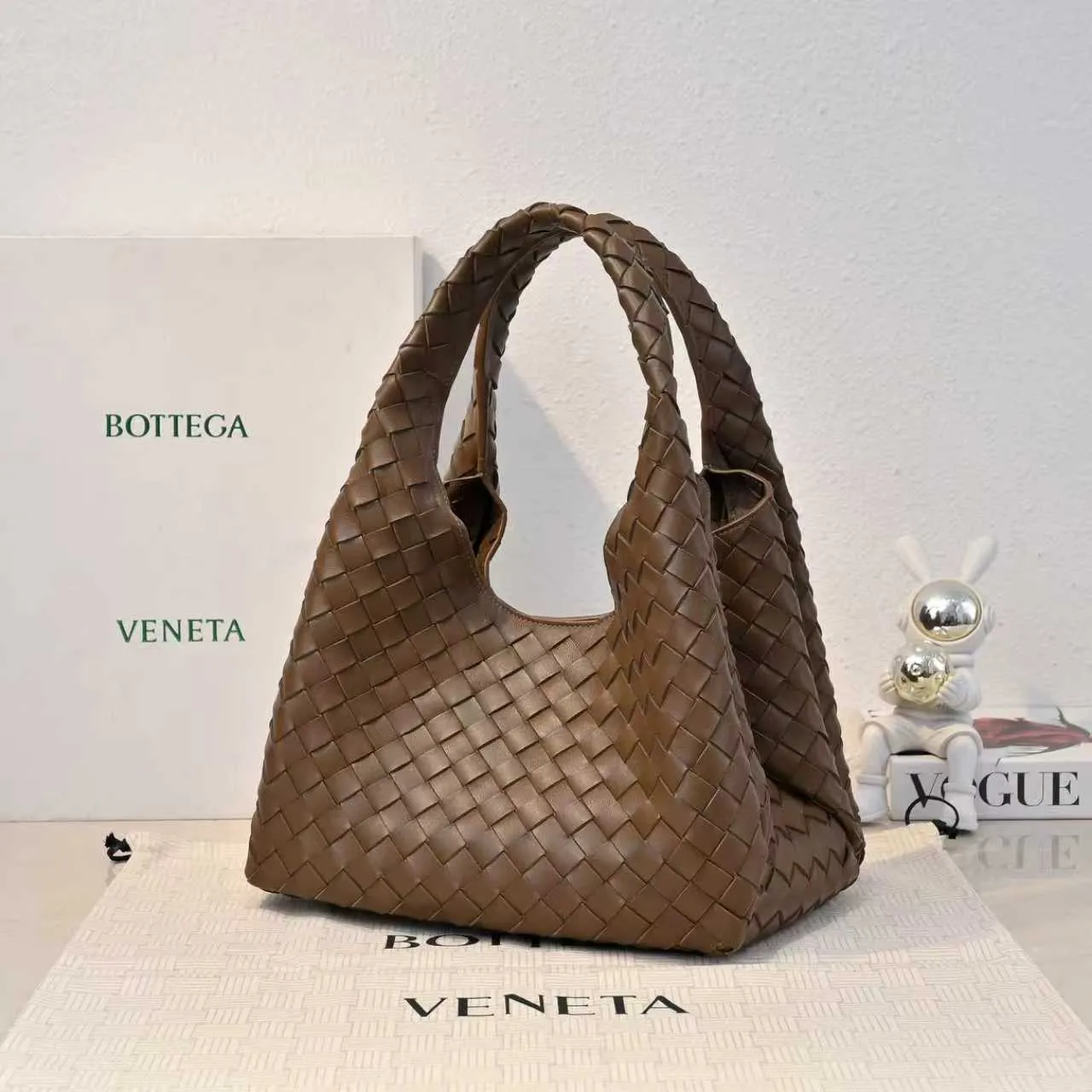 Batch 2160 new products are coming! BOTTEGA VENETA Bottega Veneta's 2025 new Campana shoulder bag is on the market~ First of all, I would like to praise the weight of this bag. As a not too small bag, it is very light for daily use. For people like me who need to carry a lot of belongings when going out, this advantage is great, and it greatly reduces the burden of traveling. 🛍️The shape is a bit like a combination of parachute and jodie. The blunt triangle shape is cute and honest. Carrying it on your back when going shopping is a good mood accelerator. The handles and body of the bag are both classic weaves. A tie is added to the original open design. If it is not tied up, the bag will look like a small vegetable basket when carried. Style number: 4249 Size: 33*20*16.5cm